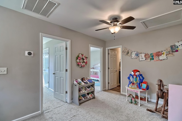 recreation room featuring light carpet and ceiling fan