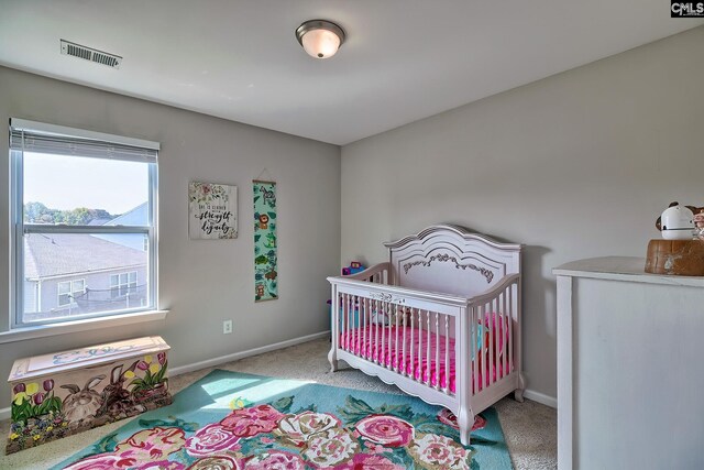 bedroom with carpet flooring and a crib