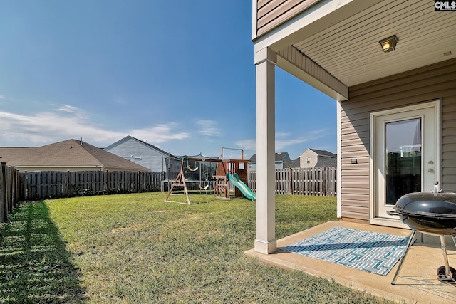 view of yard with a trampoline, a playground, and a patio