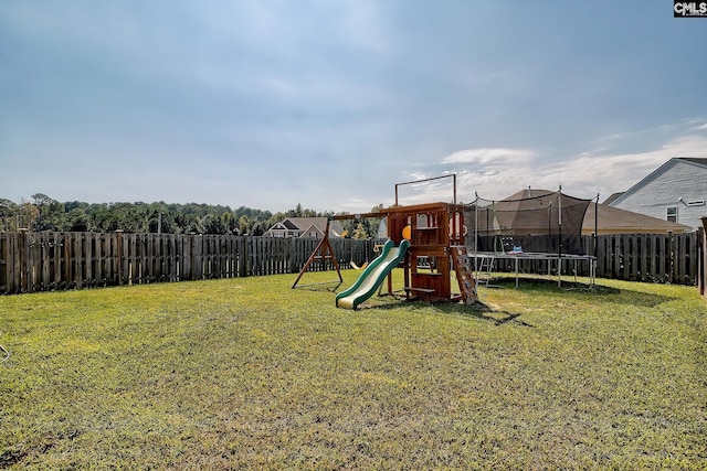 view of playground featuring a trampoline and a yard