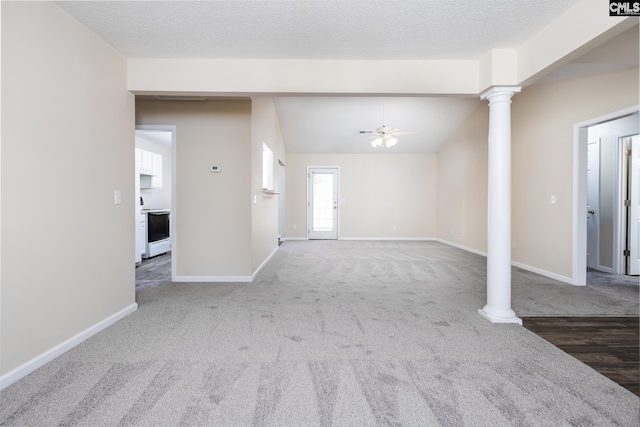 unfurnished living room with ceiling fan, a textured ceiling, and dark carpet