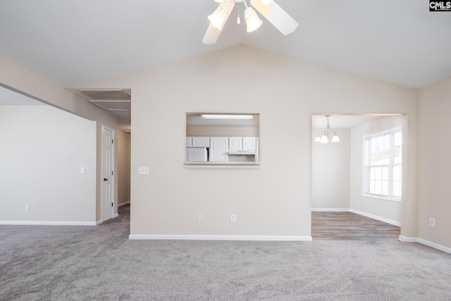 unfurnished living room with ceiling fan with notable chandelier, lofted ceiling, and carpet floors