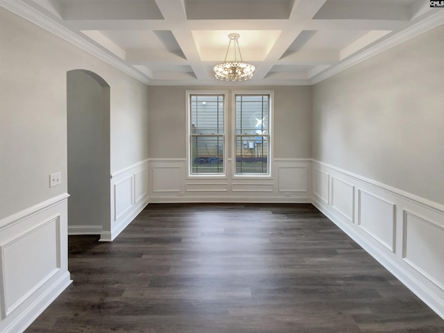 unfurnished dining area featuring beam ceiling, dark wood-type flooring, a chandelier, and coffered ceiling