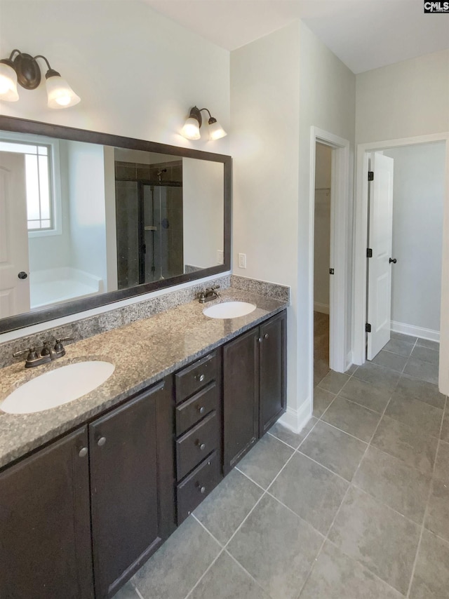 bathroom with tile patterned flooring, vanity, and separate shower and tub