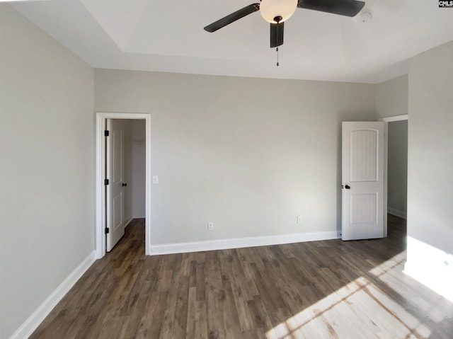 unfurnished room featuring ceiling fan and dark wood-type flooring