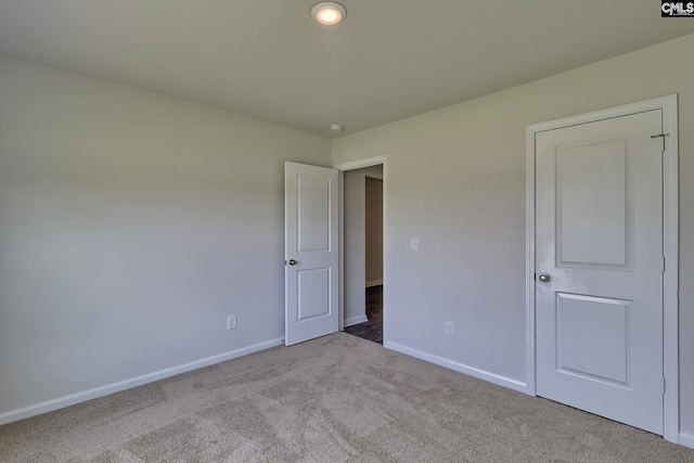 unfurnished bedroom with light colored carpet