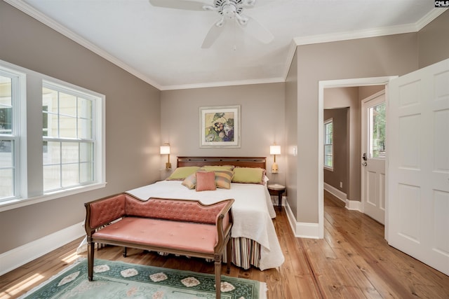 bedroom with ceiling fan, light hardwood / wood-style floors, and crown molding