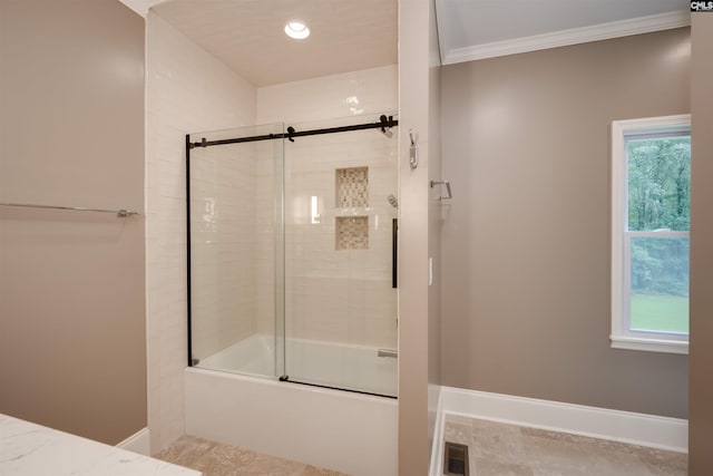 bathroom with crown molding and bath / shower combo with glass door