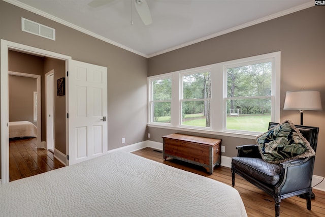 bedroom with ceiling fan, wood-type flooring, and ornamental molding