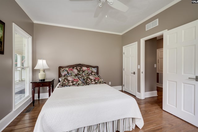 bedroom with dark hardwood / wood-style floors, ceiling fan, and crown molding