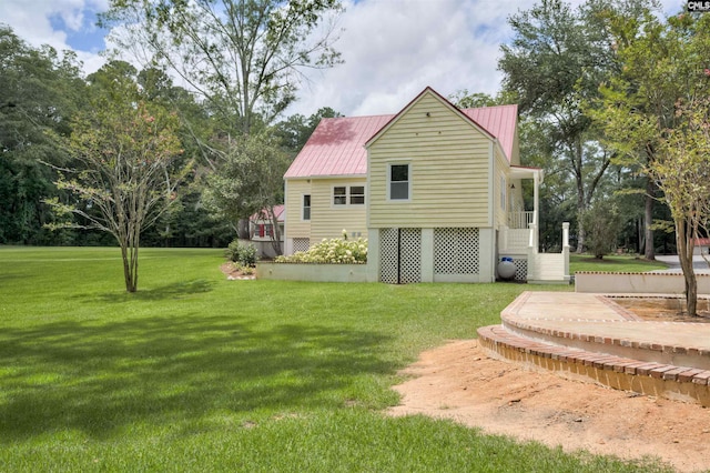 rear view of house featuring a lawn