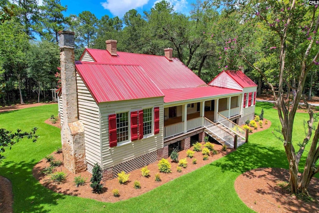 back of house with a yard and covered porch