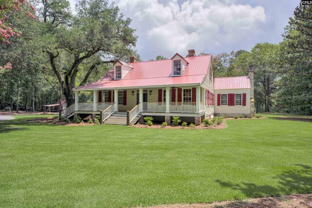 new england style home with a porch and a front lawn