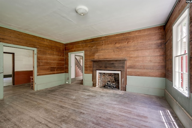 unfurnished living room with wood walls