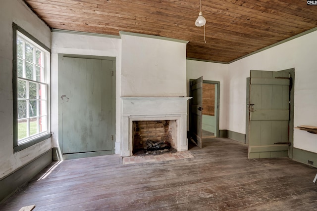 unfurnished living room with dark hardwood / wood-style flooring, ornamental molding, and wood ceiling