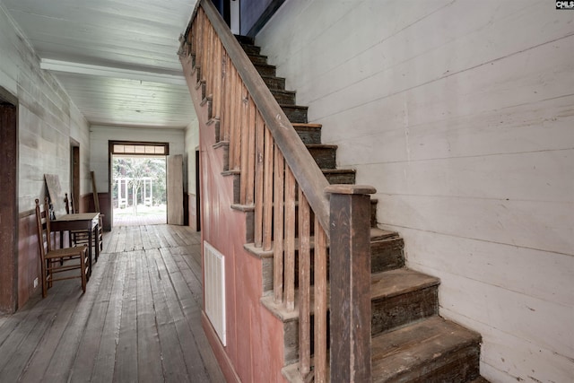 staircase with beamed ceiling, wood-type flooring, and wooden ceiling