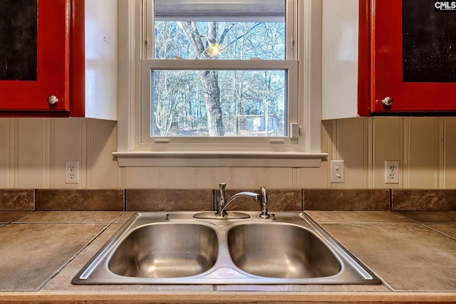 kitchen featuring tile counters and sink