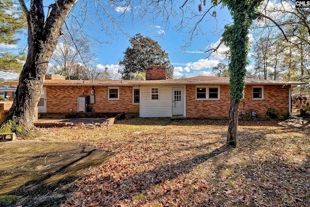 back of house with a yard and a patio area