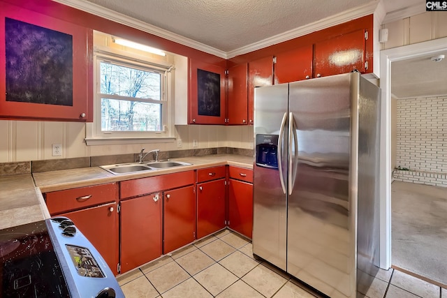 kitchen featuring sink, stainless steel fridge with ice dispenser, crown molding, a textured ceiling, and light tile patterned flooring