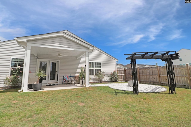 back of house with a lawn, a pergola, ceiling fan, and a patio