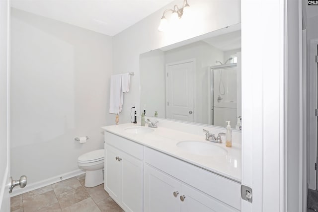 bathroom featuring vanity, toilet, and a shower with shower door