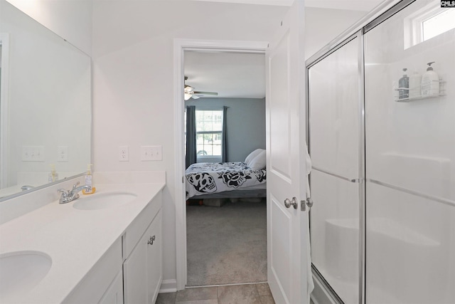 bathroom featuring ceiling fan, a shower with shower door, and vanity