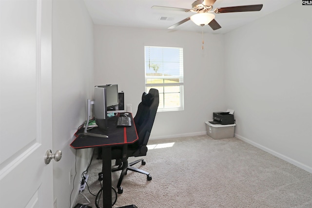 carpeted home office with ceiling fan