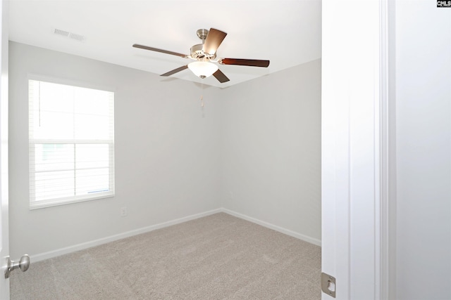 carpeted empty room with ceiling fan and a healthy amount of sunlight