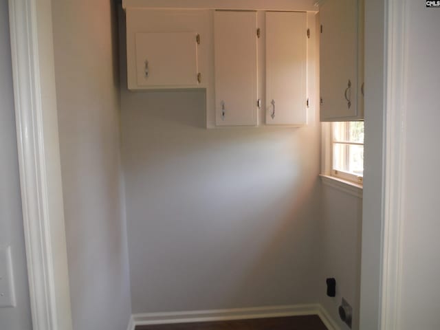 clothes washing area featuring cabinets