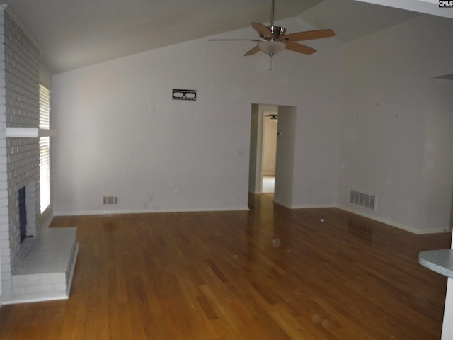 unfurnished living room with dark hardwood / wood-style flooring, a brick fireplace, ceiling fan, and lofted ceiling