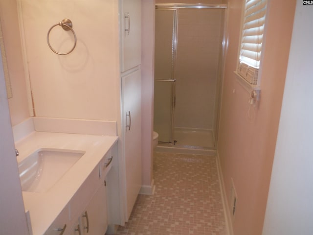 bathroom with vanity, an enclosed shower, and toilet