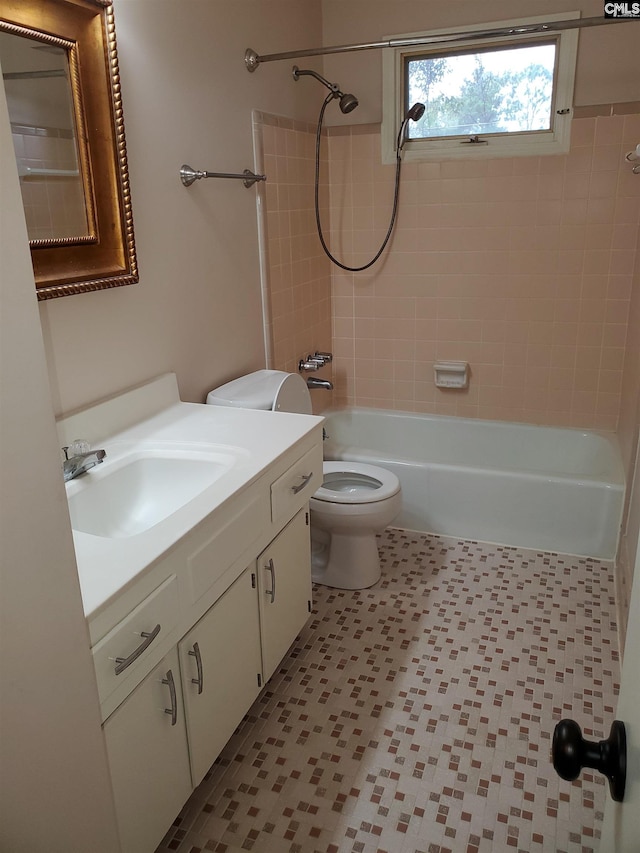 full bathroom featuring vanity, toilet, and tiled shower / bath