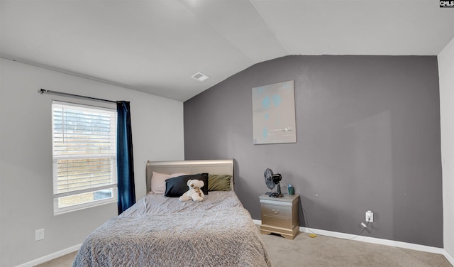 bedroom with light colored carpet, multiple windows, and vaulted ceiling