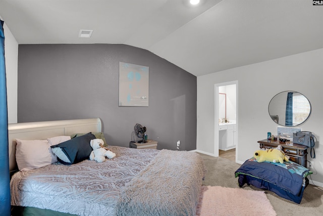 carpeted bedroom with lofted ceiling, ensuite bathroom, visible vents, and baseboards