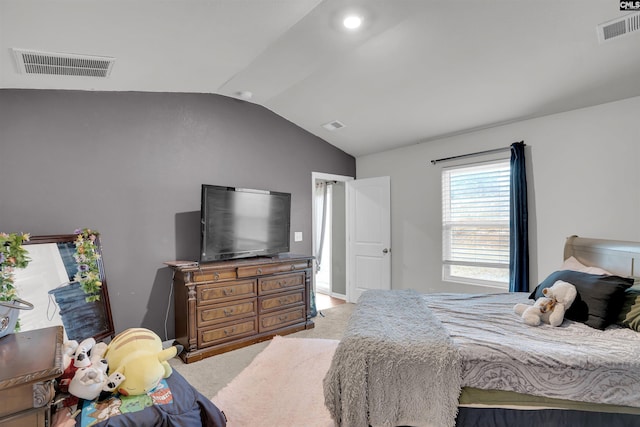 carpeted bedroom with visible vents and vaulted ceiling