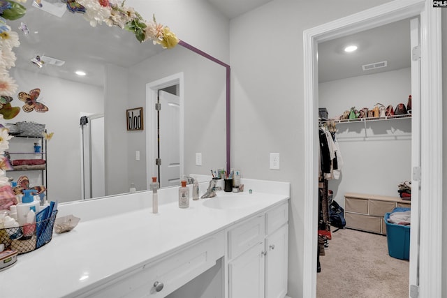 full bath featuring a walk in closet, recessed lighting, visible vents, an enclosed shower, and vanity