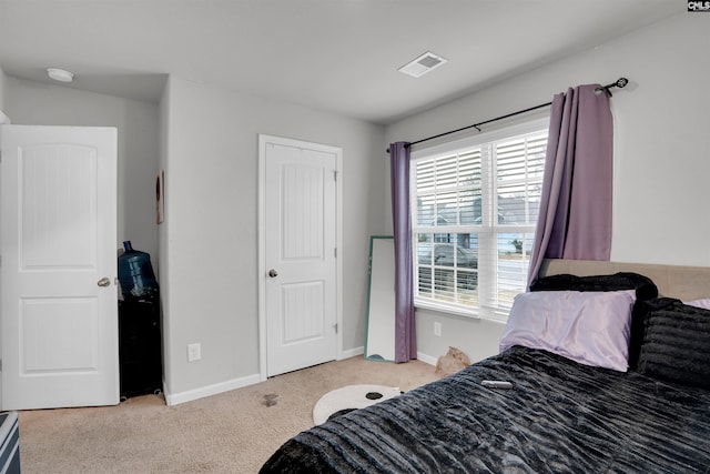 carpeted bedroom with baseboards and visible vents