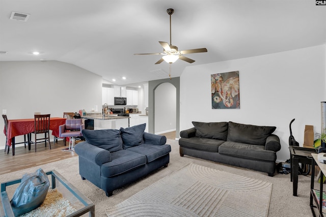 living room featuring visible vents, arched walkways, a ceiling fan, lofted ceiling, and recessed lighting