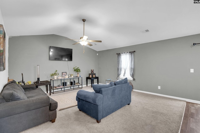 living room featuring visible vents, vaulted ceiling, baseboards, and ceiling fan