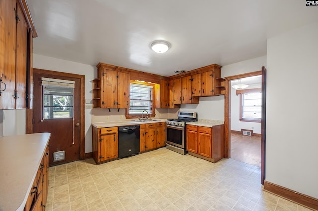 kitchen with black dishwasher, stainless steel range with gas cooktop, plenty of natural light, and sink