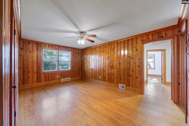 spare room with ceiling fan, light hardwood / wood-style flooring, and crown molding