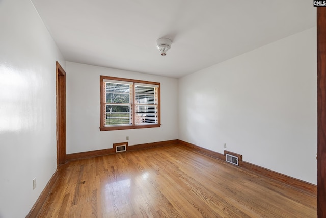 spare room featuring light wood-type flooring