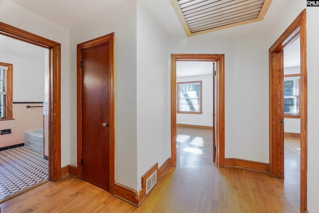 hall with light hardwood / wood-style floors