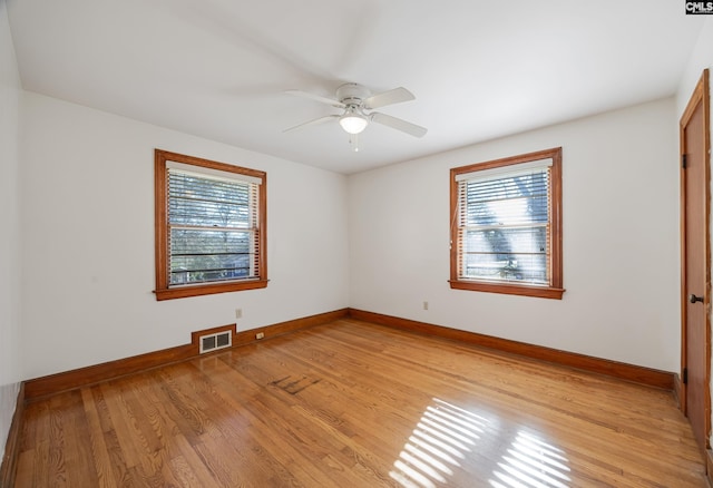 unfurnished room with ceiling fan and light wood-type flooring