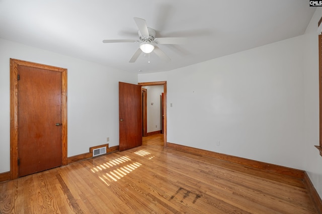 spare room with ceiling fan and light wood-type flooring