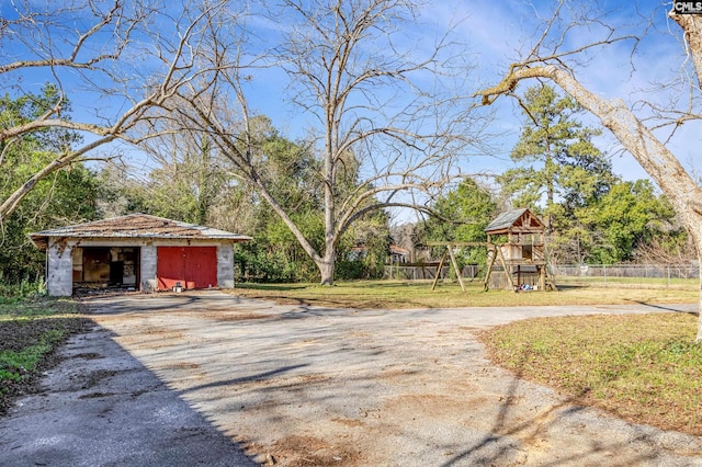 view of yard featuring an outbuilding and a playground