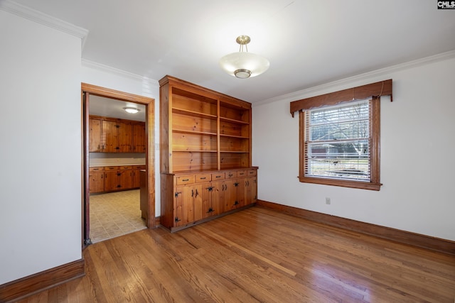 unfurnished room with light hardwood / wood-style floors and ornamental molding