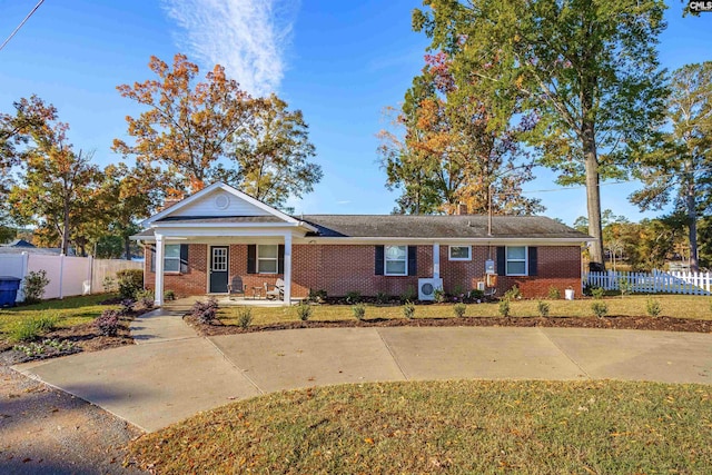 view of front of house with covered porch and a front yard