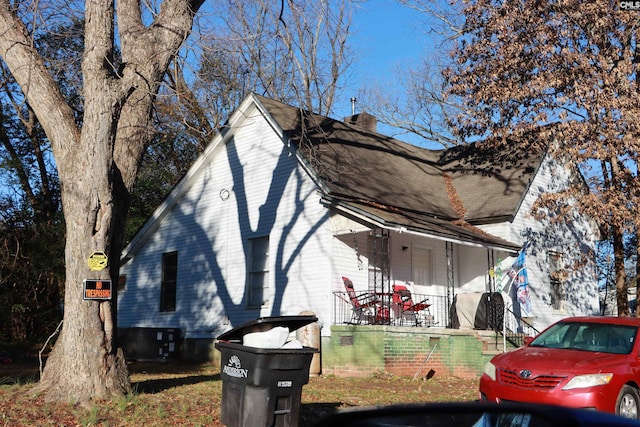 view of side of property with covered porch