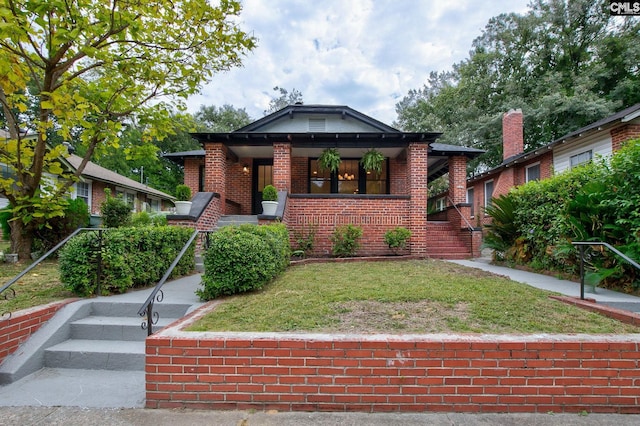 bungalow-style home with a front yard